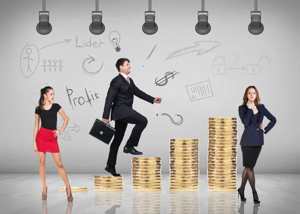 Businessman climbing gold coins stacks — Stock Photo, Image