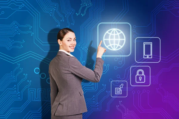 Smiling business woman point to the icon — Stock Photo, Image