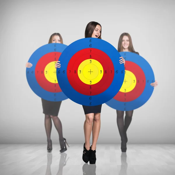 Business women smiling and holding big target — Stock Photo, Image