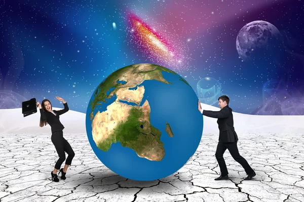 Businessman pushes world sphere