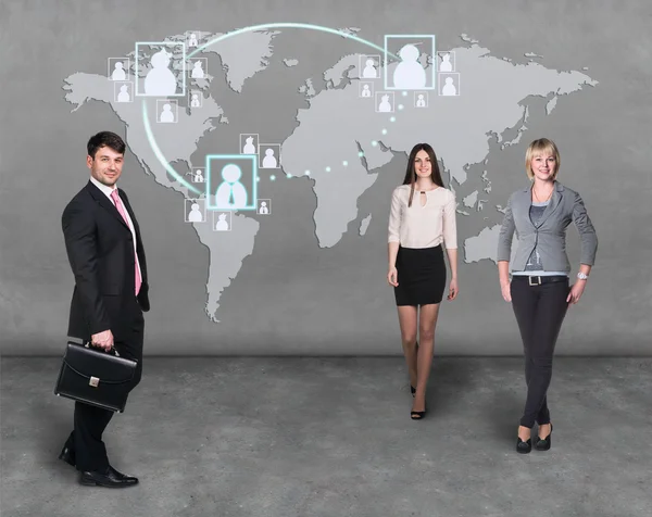 Businessmen standing in front of an earth map — Stock Photo, Image