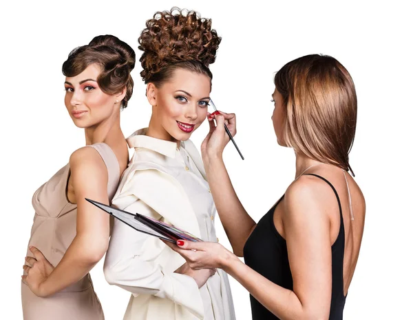 Make-up artist applying liner on models eyebrows — Stock Photo, Image