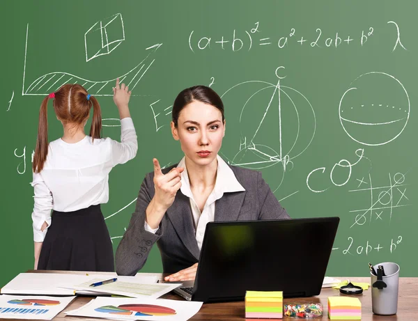 Teacher sitting at the desk — Stock Photo, Image