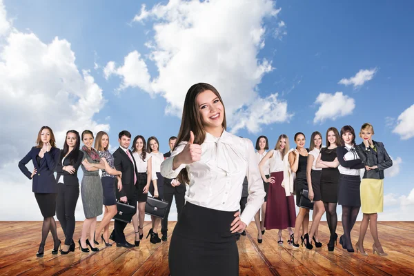 Group of business people stand under clouds sky. — Stock Photo, Image