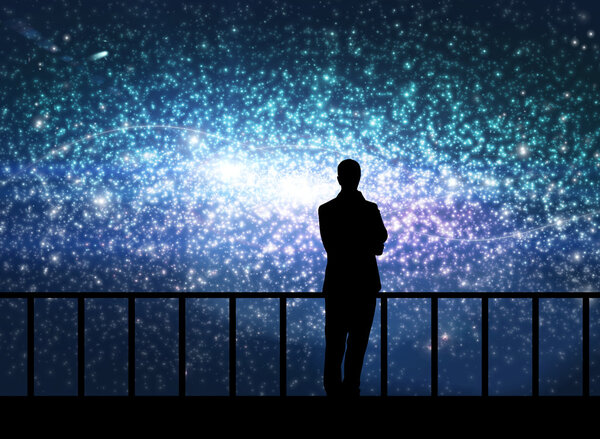 Silhouette of young man stands on the bridge in cosmos