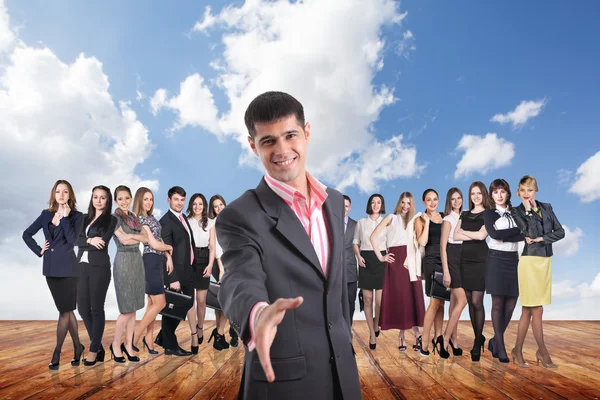 Group of business people stand under clouds sky. — Stock Photo, Image