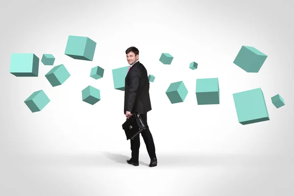 Business man near with turquoise cubes — Stock Photo, Image