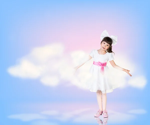 Little girl in sky clouds — Stock Photo, Image