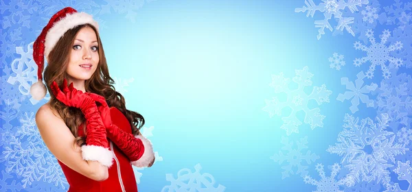 Santa flicka står bland snöflingor — Stockfoto