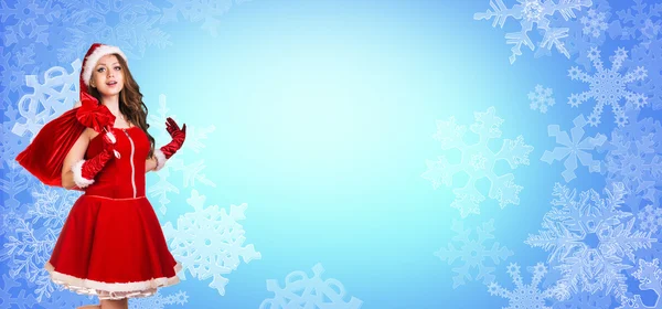 Santa girl stands among snowflakes — Stock Photo, Image