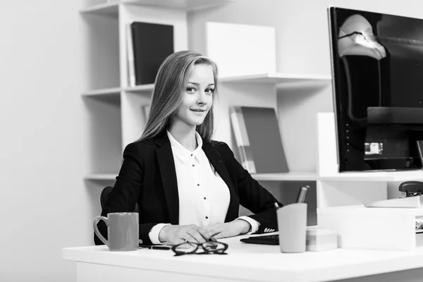 Mujer sentada en el escritorio con computadora — Foto de Stock