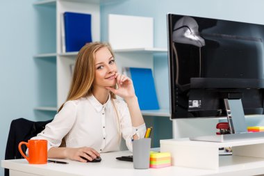 Masa başında bilgisayarla oturan kadın