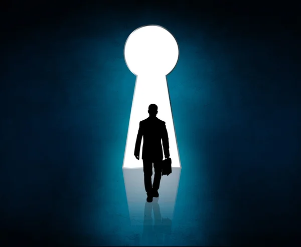 Silhouette stands near big keyhole exit. — Stock Photo, Image