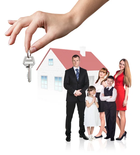 Big hand give keys to young family — Stock Photo, Image