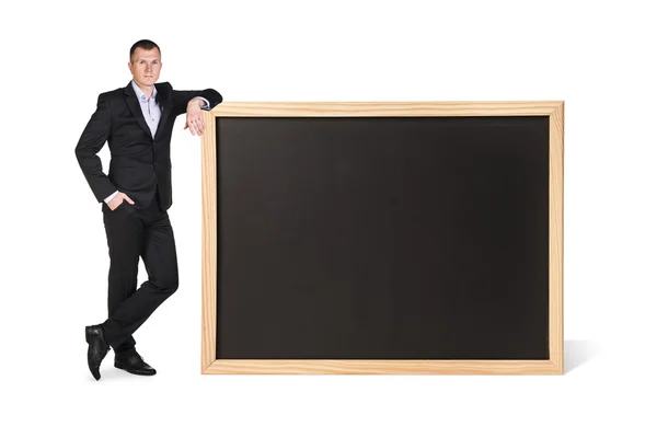 Young woman stands near big chalkboard — Stock Photo, Image