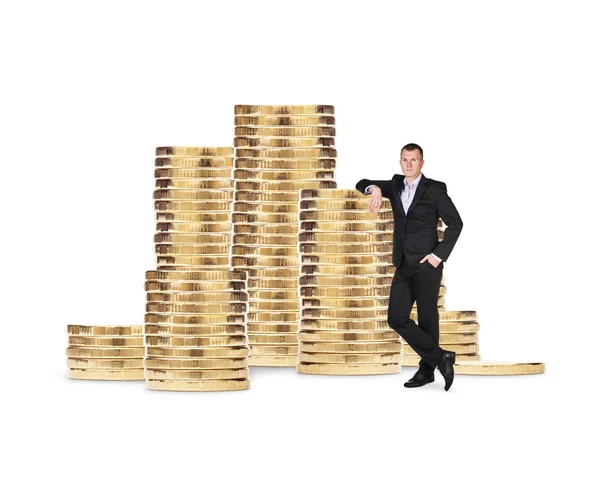 Businessman near stack of golden coins — Stock Photo, Image