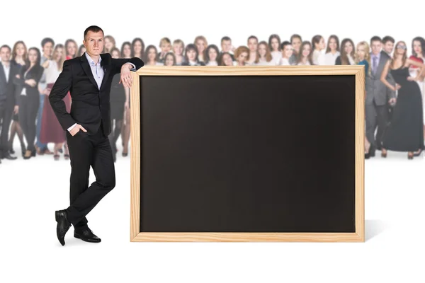 Young woman stands near big chalkboard — Stock Photo, Image