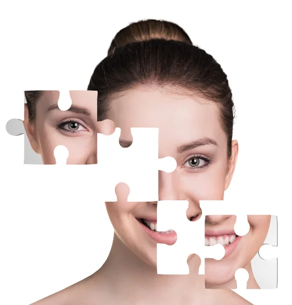 Face of  beautiful young woman with a puzzle parts — Stock Photo, Image