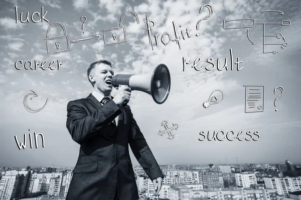 Businessman on the roof with megaphone — Stock Photo, Image