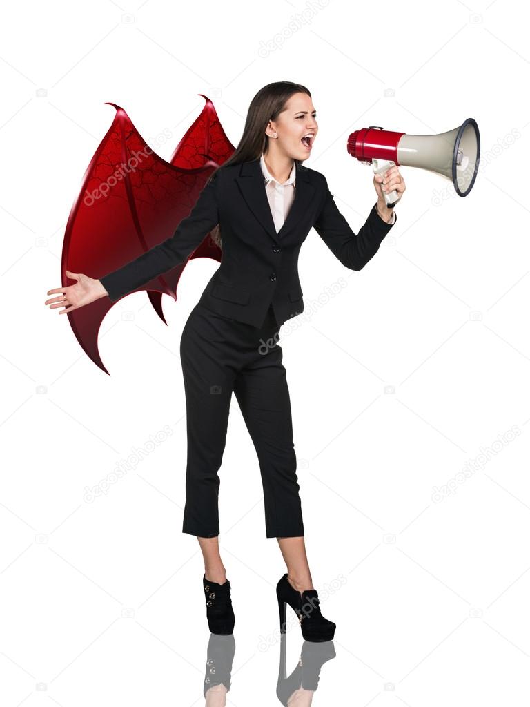 Business woman devil screams to megaphone