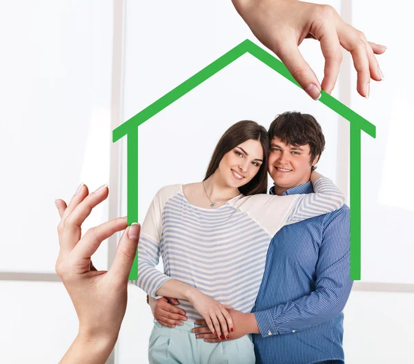 Green house shape with young family inside — Stock Photo, Image