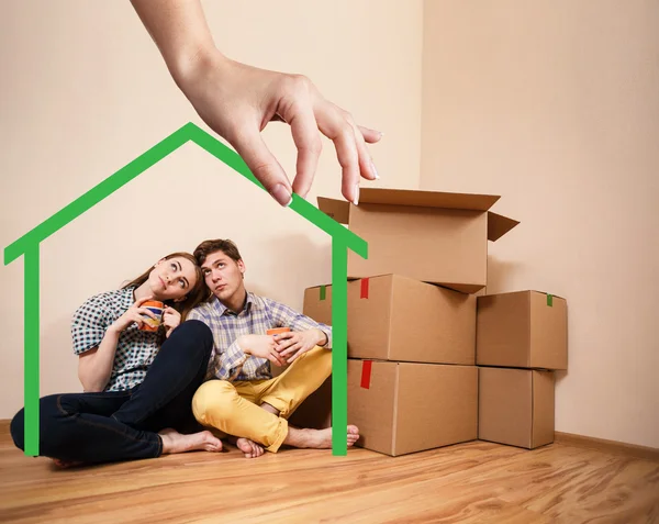 Green house shape with young family inside — Stock Photo, Image