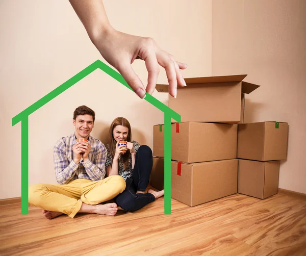 Green house shape with young family inside — Stock Photo, Image