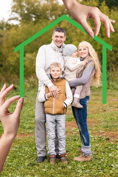 Big hand give keys to young family — Stock Photo, Image