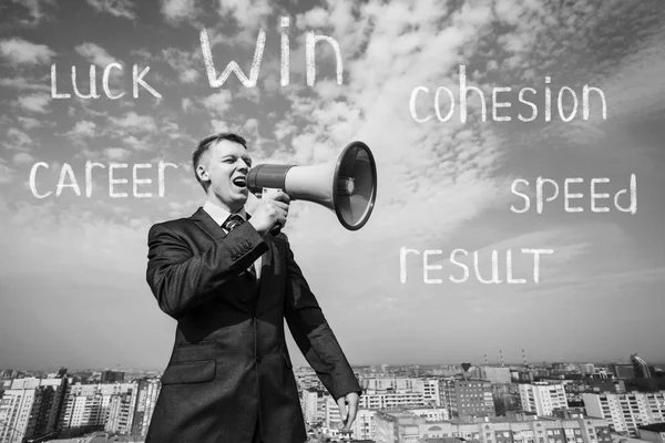 Businessman on the roof with megaphone — Stock Photo, Image