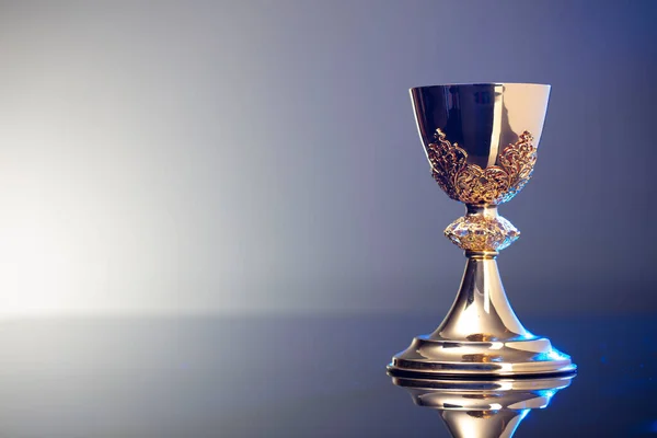 Catholic religion concept background. Golden chalice, place for text.