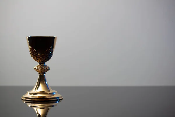 Catholic religion concept background. Golden chalice, place for text.