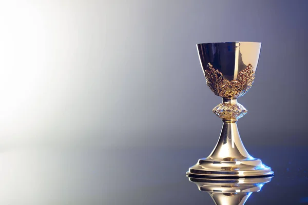 Catholic religion concept background. Golden chalice, place for text.
