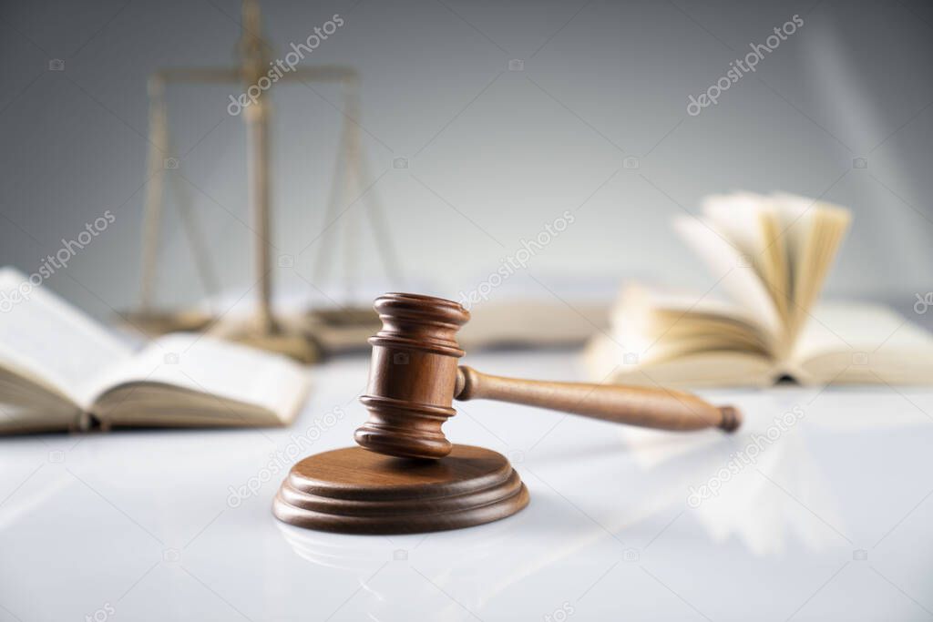 Law and justice concept. Gavel, legal code and scale on the off-white background.
