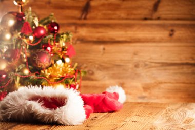 Noel Baba günü konsepti. Altın ve kahverengimsi estetik ve Noel Baba şapkasıyla Noel süslemesi. Tipografi veya metin için yer. 