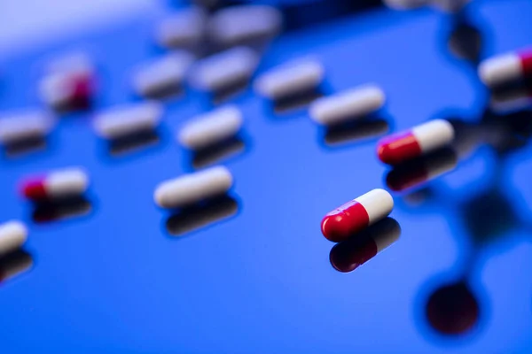 Global healthcare concept. Stethoscope and medicines. Blue table and background.