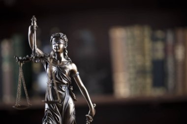 Hukuk kavramı. Avukatlık bürosu. Raftaki heykel hukuk kitaplarının arka planında.. 