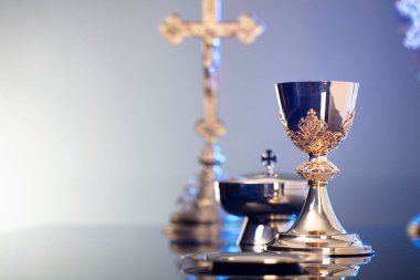 Din temalı Paskalya. Katolik sembolleri kompozisyonu. Haç, monarşi ve altın kadeh mavi arka planda.. 