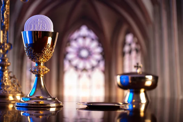 First Holy Communion. Catholic religion theme. Crucifix, the Croass and Golden chalice and wafer on the altar.