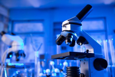 Coronavirus salgını teması. Hızlı covid testleri ve anti-covid aşısıyla ilgili bilimsel araştırma. Laboratuvarda mikroskop, deney tüpleri ve deney tüpleri var..