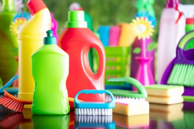 Spring house and office cleaning. Cleaning kit and sources on the glass table. Bokeh  background.