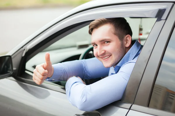 Man doing thumbs up in car — Stock Photo, Image