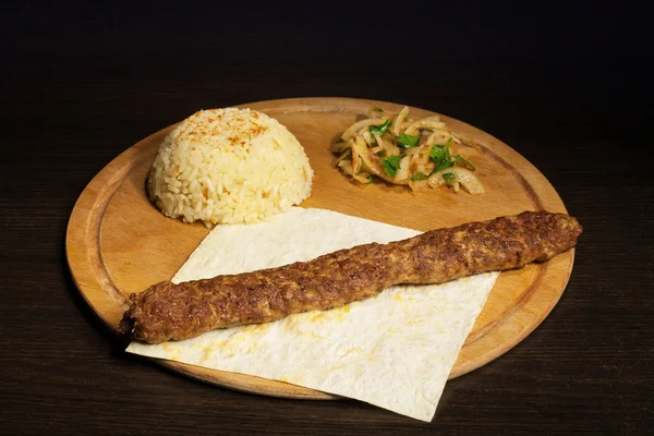 Barbecue with rice on Wooden Chopping Board at the table. — Stock Photo, Image