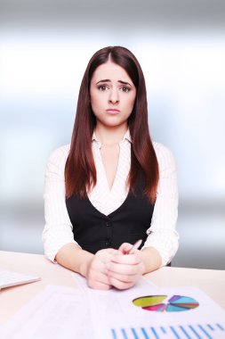 Portrait of a beautiful young business woman doing some paperwor