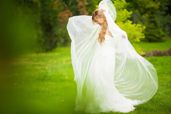 Portrait of a beautiful blonde bride with wedding bouqet in the — Stock Photo, Image