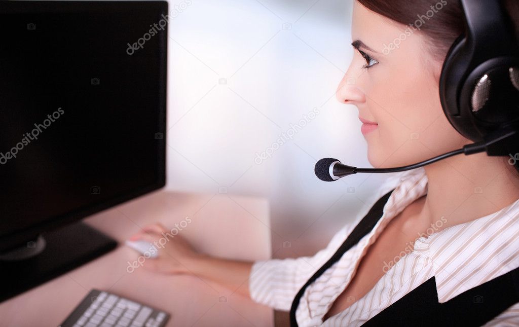 businesswoman with headset working on computer 