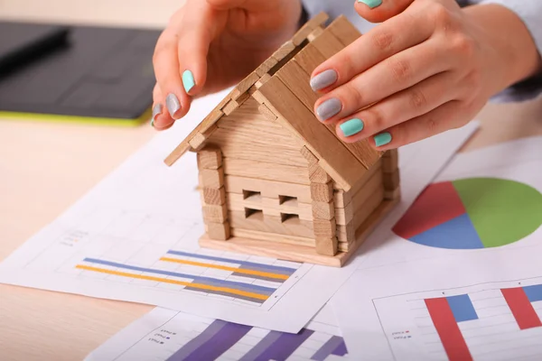 Woman giving a small home safety with her hands as a roof — Stock Photo, Image