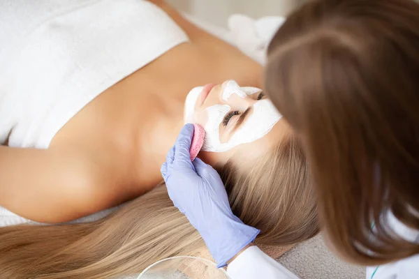 Spa Woman applying Facial cleansing Mask, Beauty Treatments