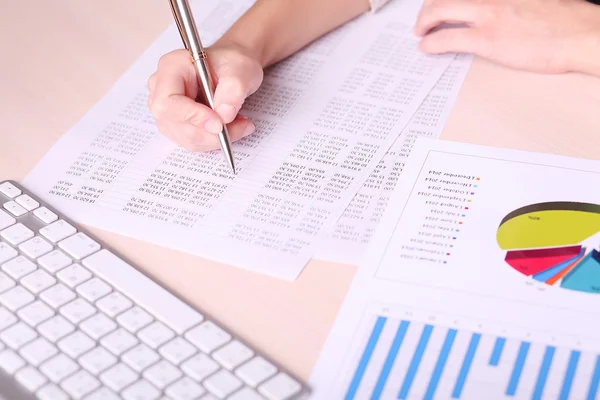 Picture of woman hand writing on paper with numbers — Stock Photo, Image