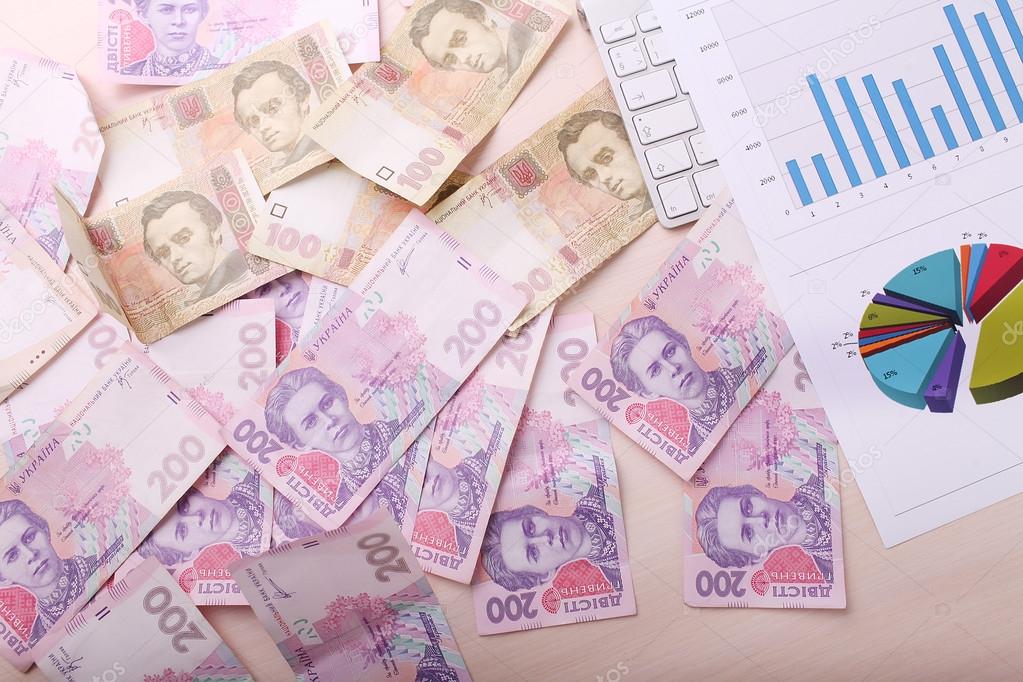 Heap of ukrainian hryvna, on moneys background 