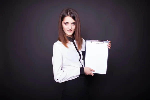 Smiling business woman holding blank clipboard — Stock Photo, Image